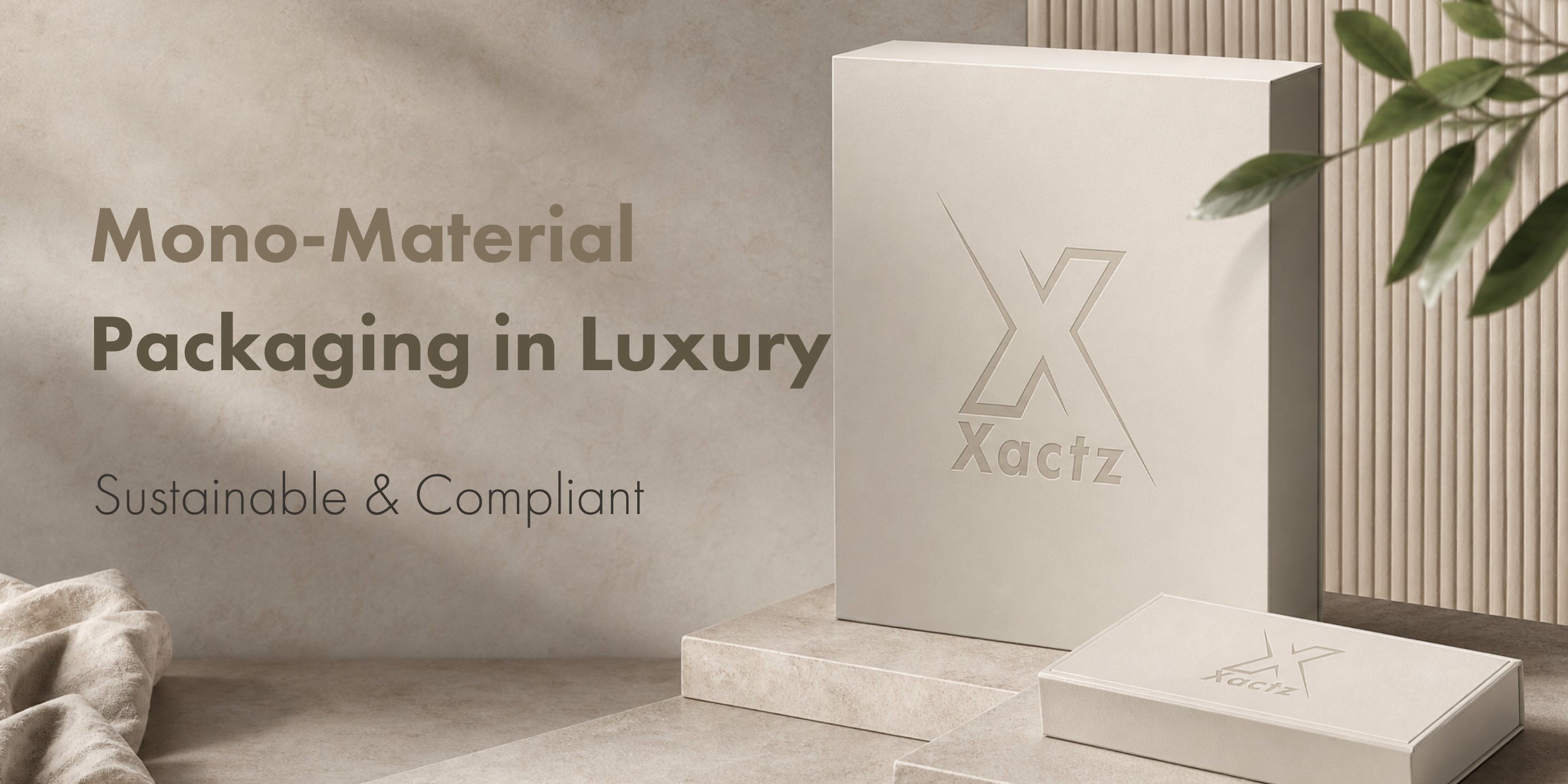 Xactz mono-material luxury packaging blog cover featuring custom debossed cream-colored paperboard rigid boxes on a minimalist stone display with sustainable design text