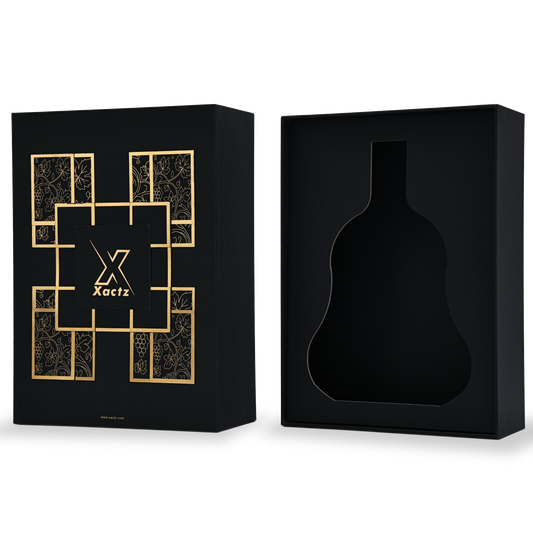 Luxury rigid wine gift box open three quarter view showing matte gold foil stamped lid and custom wine bottle silhouette die-cut insert in deep black interior