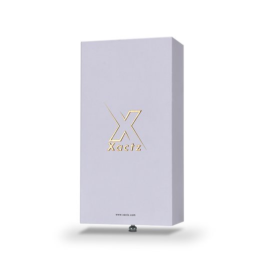 Lavender-white Xactz rigid drawer box with embossed gold foil logo, three-quarter angle view against white background.
