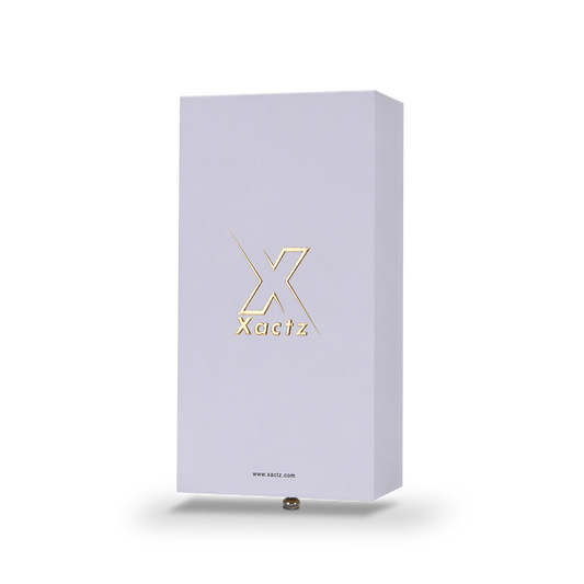 Lavender-white rigid drawer box with embossed matte gold foil Xactz logo, three-quarter angle view.