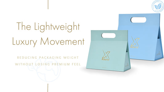 Xactz lightweight luxury custom packaging boxes in mint green and sky blue with gold foil logo stamping and die-cut handles, eco-friendly premium packaging that reduces weight without losing luxury feel.