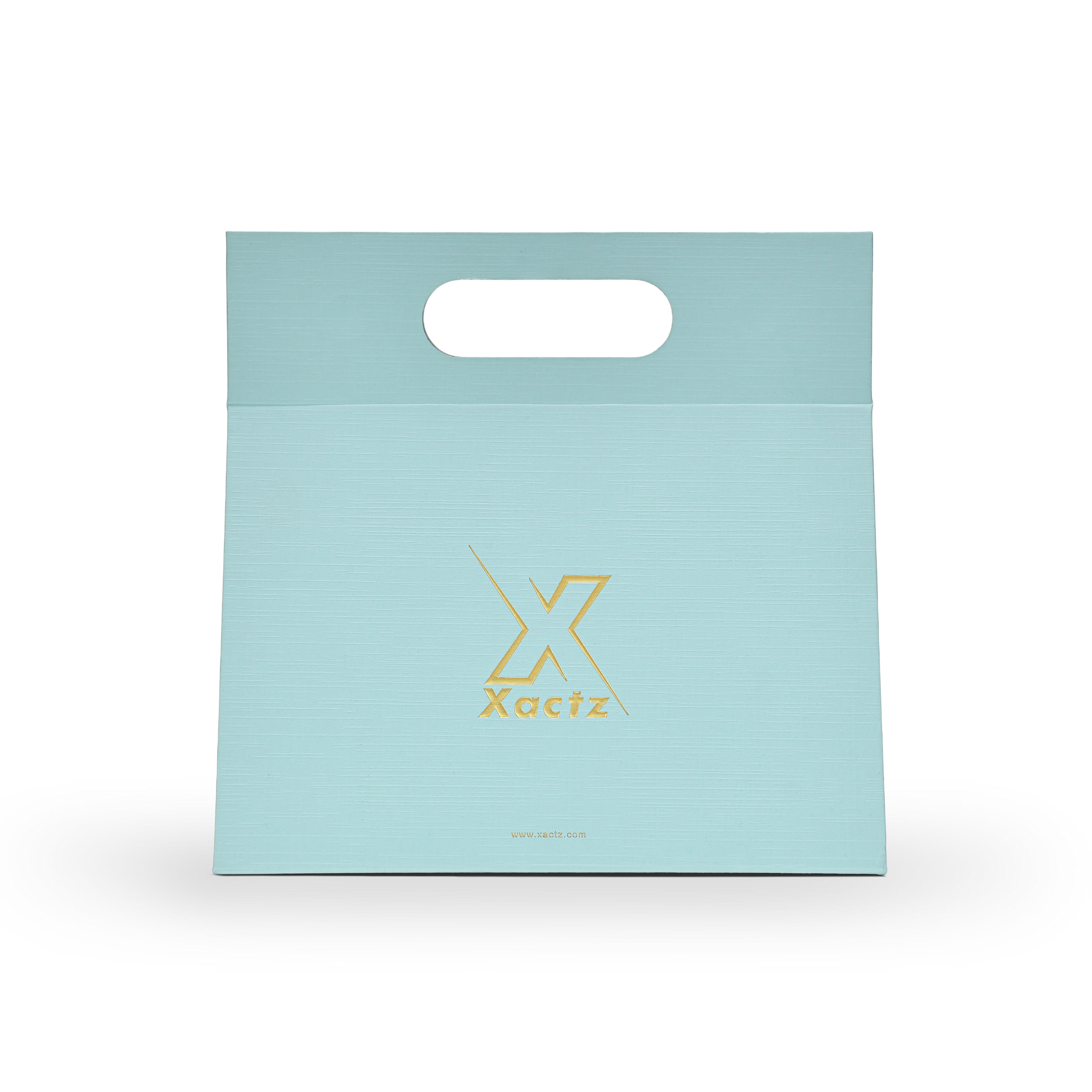 Custom foldable gift box bag with handle in sky blue linen specialty paper showing the full front panel with a centered embossed matte gold foil Xactz logo on the smooth linen texture surface and a die cut carry handle cutout at the top