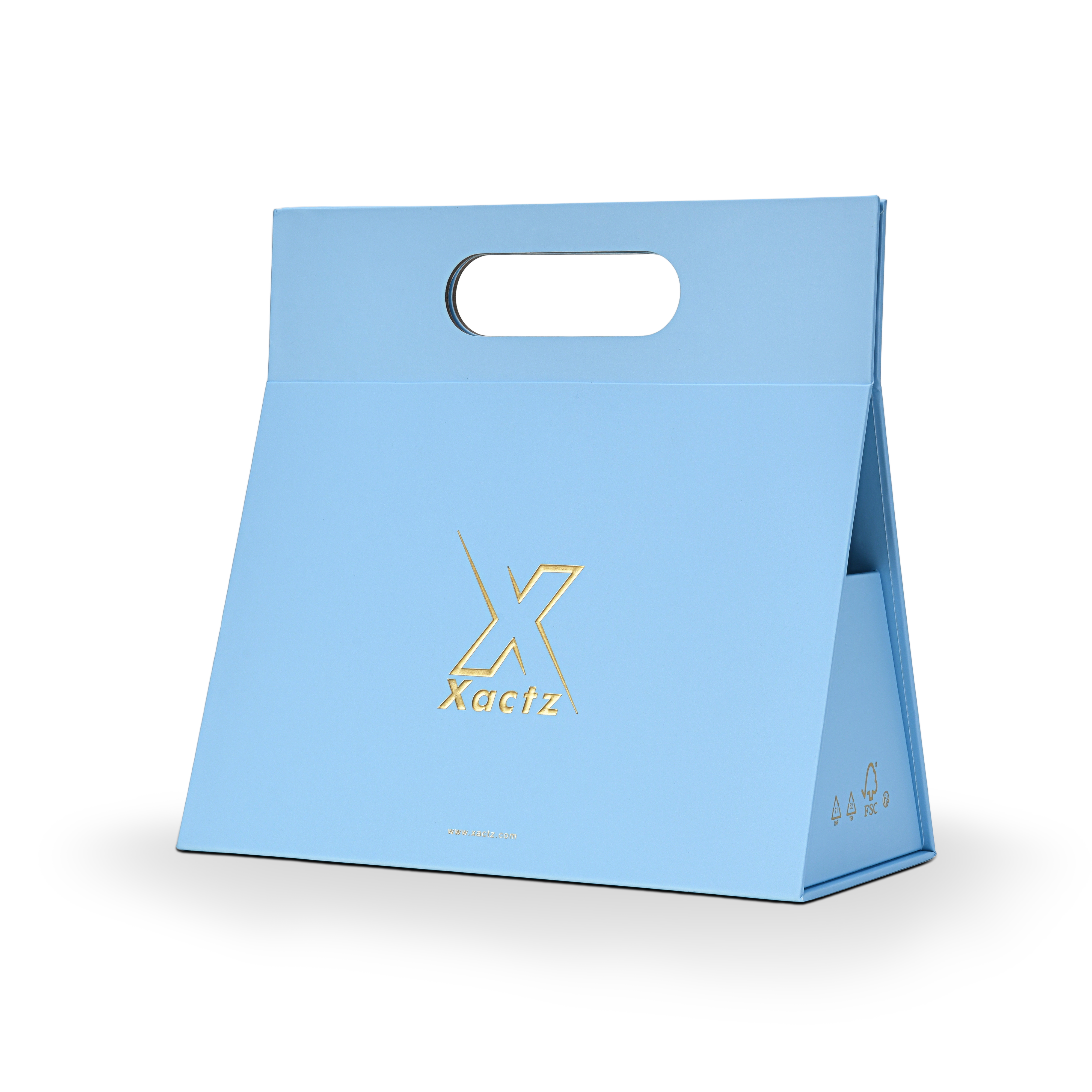 Three quarter angled view of a custom foldable gift box bag with handle in sky blue art paper showing the trapezoidal assembled structure with embossed gold foil logo and FSC certification marks on the side panel
