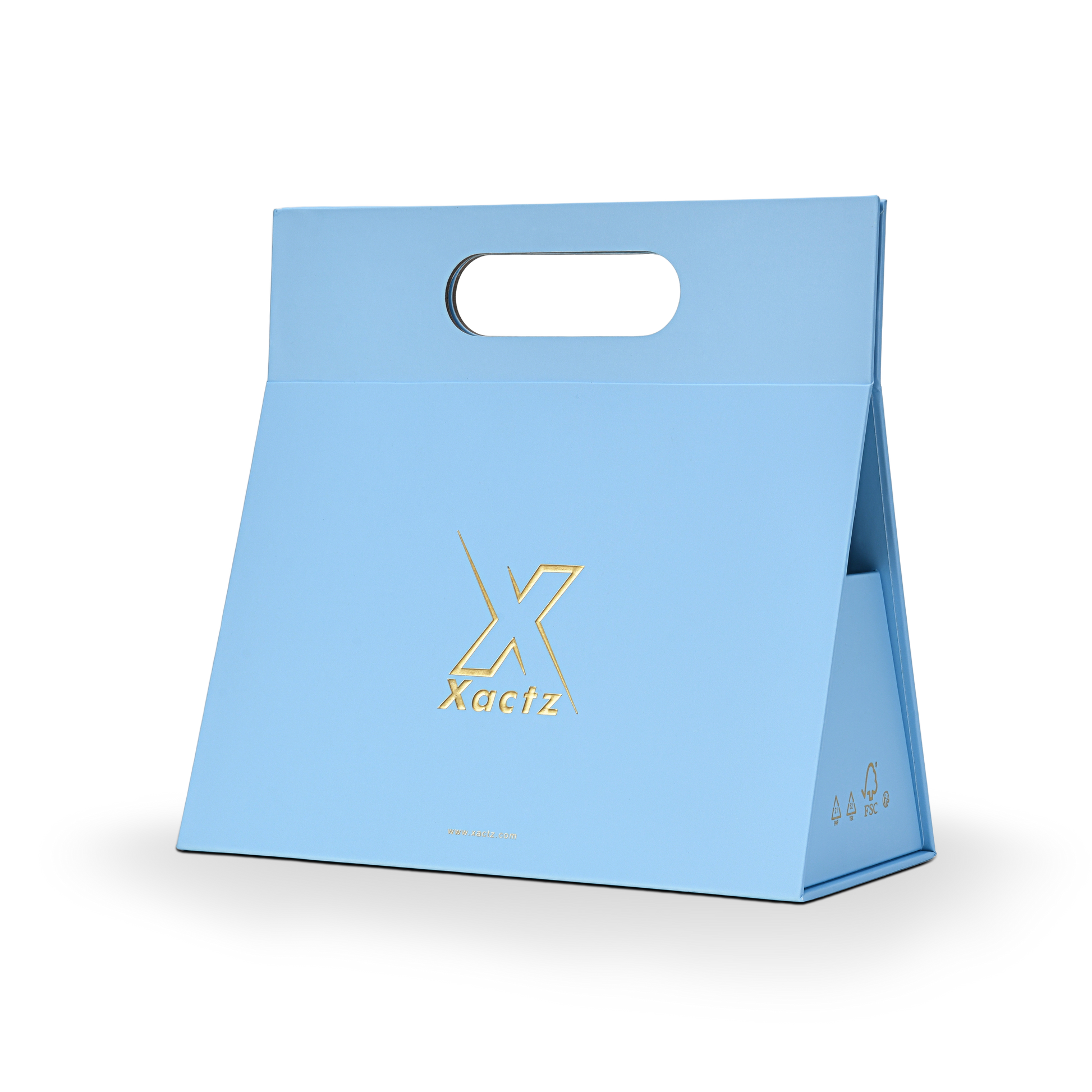 Three quarter angled view of a custom foldable gift box bag with handle in sky blue art paper showing the trapezoidal assembled structure with embossed gold foil logo and FSC certification marks on the side panel