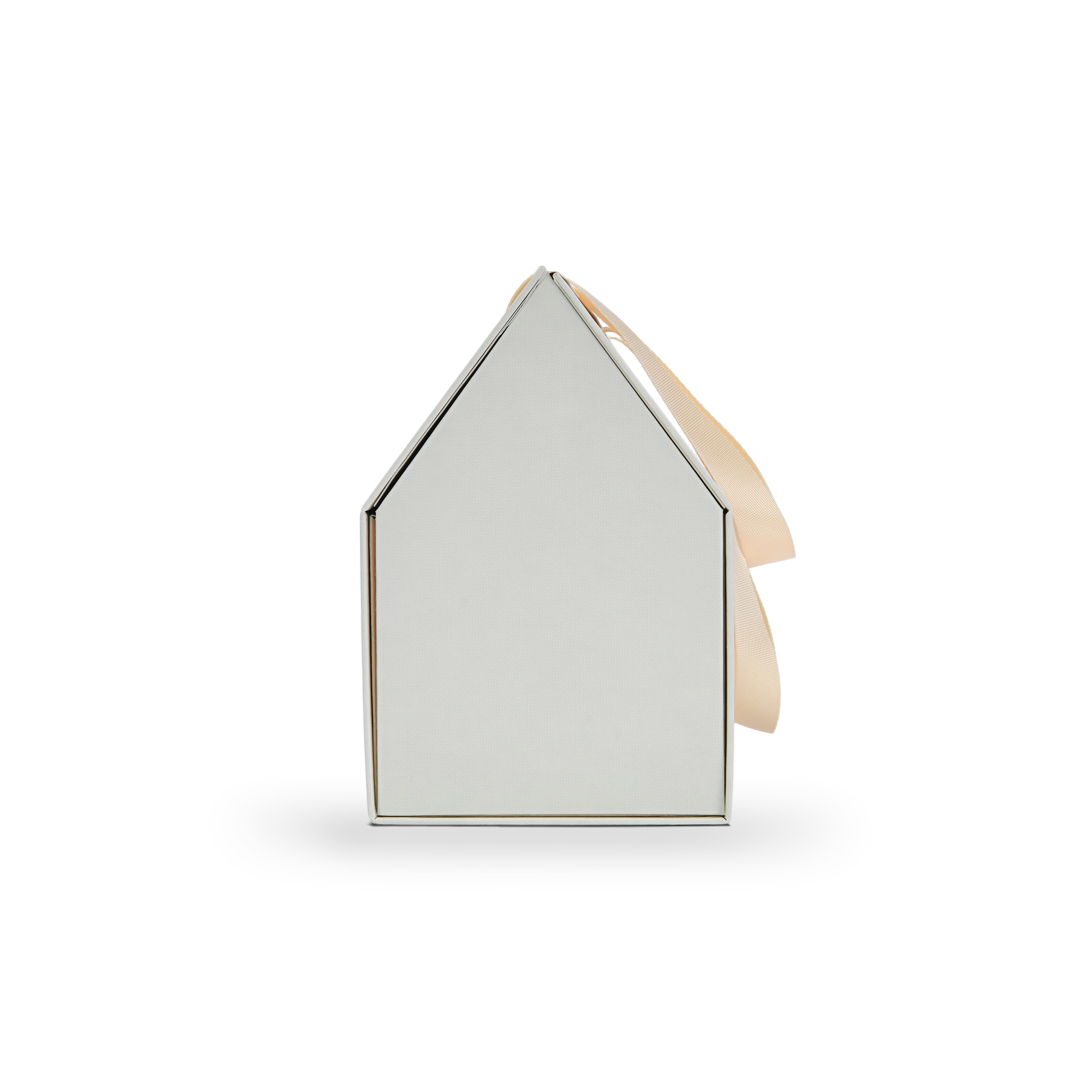 Side profile view of a closed custom house shaped foldable gift box showing the clean triangular roof line and the elegant beige ribbon handle draped over the side