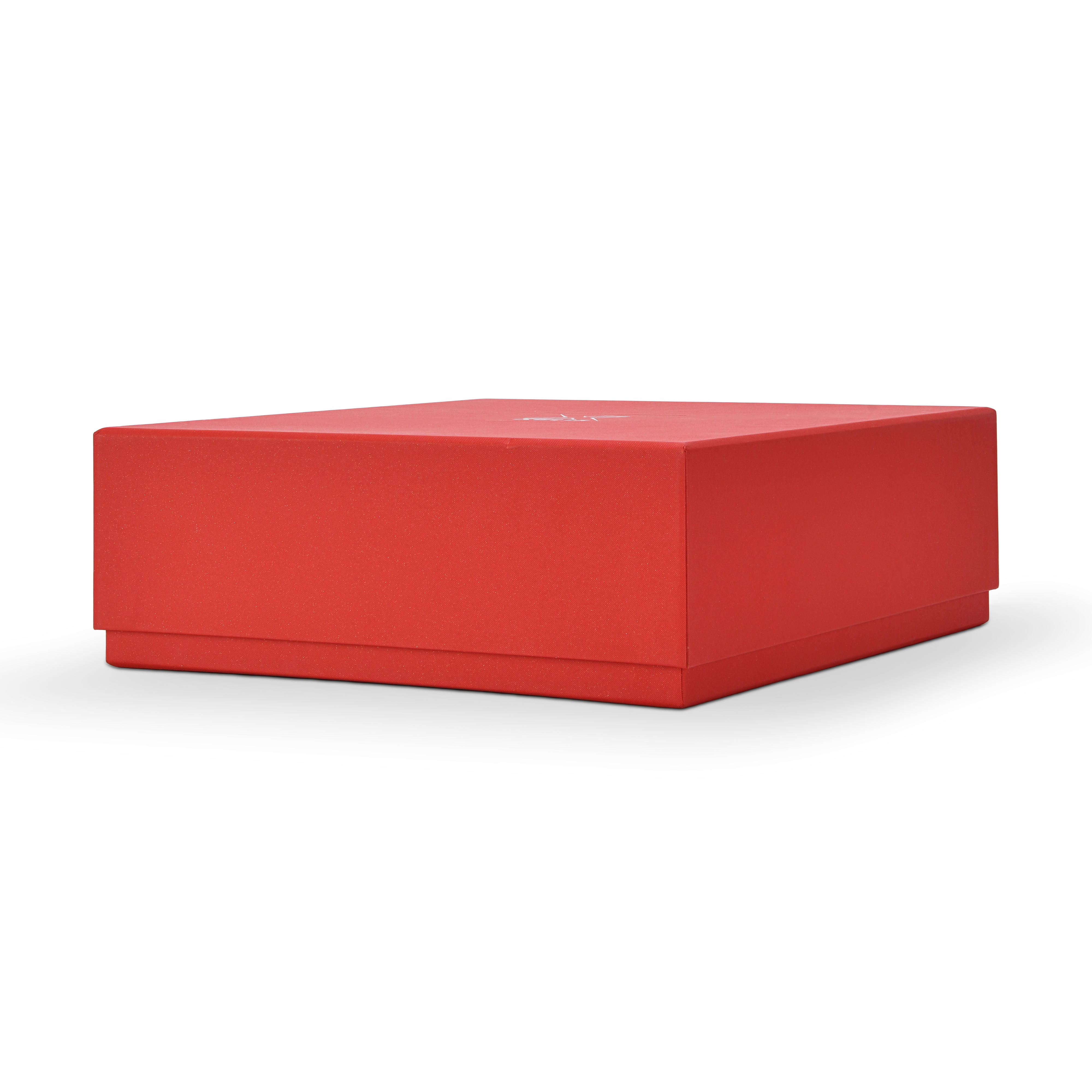 Low profile three quarter angled view of a custom red lid and base gift box for cosmetics shown in landscape orientation displaying the full red star rain specialty paper surface across the top lid panel and the clean fitted lid and base construction with the silver foil Xactz logo visible on the top face