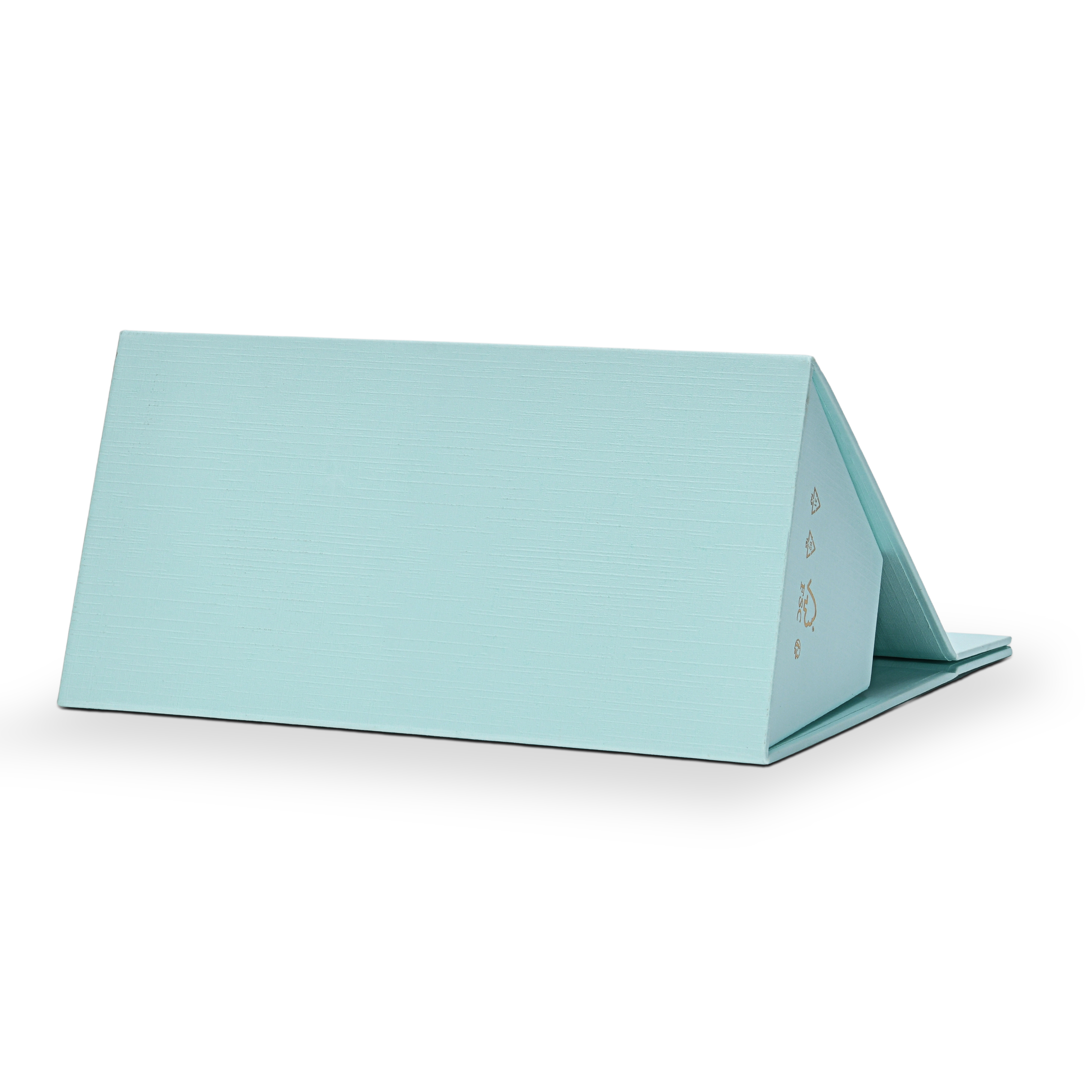 Custom foldable gift box bag with handle in sky blue linen specialty paper shown fully folded flat in a horizontal position displaying the clean back panel surface with the linen texture visible across the full width and FSC certification marks in gold on the right edge