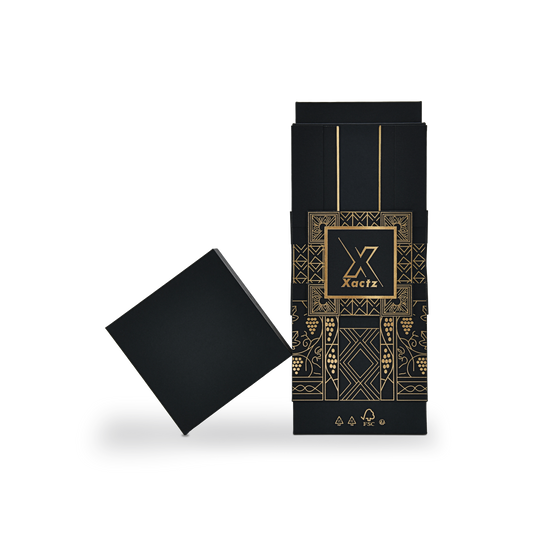 Custom all black rigid wine gift box with the matte black square lid removed and tilted at a diagonal angle beside the upright black collared base showing the full gold foil grape vine and geometric tile illustration and the FSC certification marks printed in gold at the base