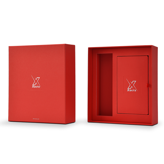 Three quarter angled view of a custom red lid and base gift box for cosmetics with the lid positioned beside the open base displaying the deep red star rain specialty paper exterior on the lid and the matching red interior of the base with the inner tray showing the product cavity and Xactz branded card insert with silver foil logo