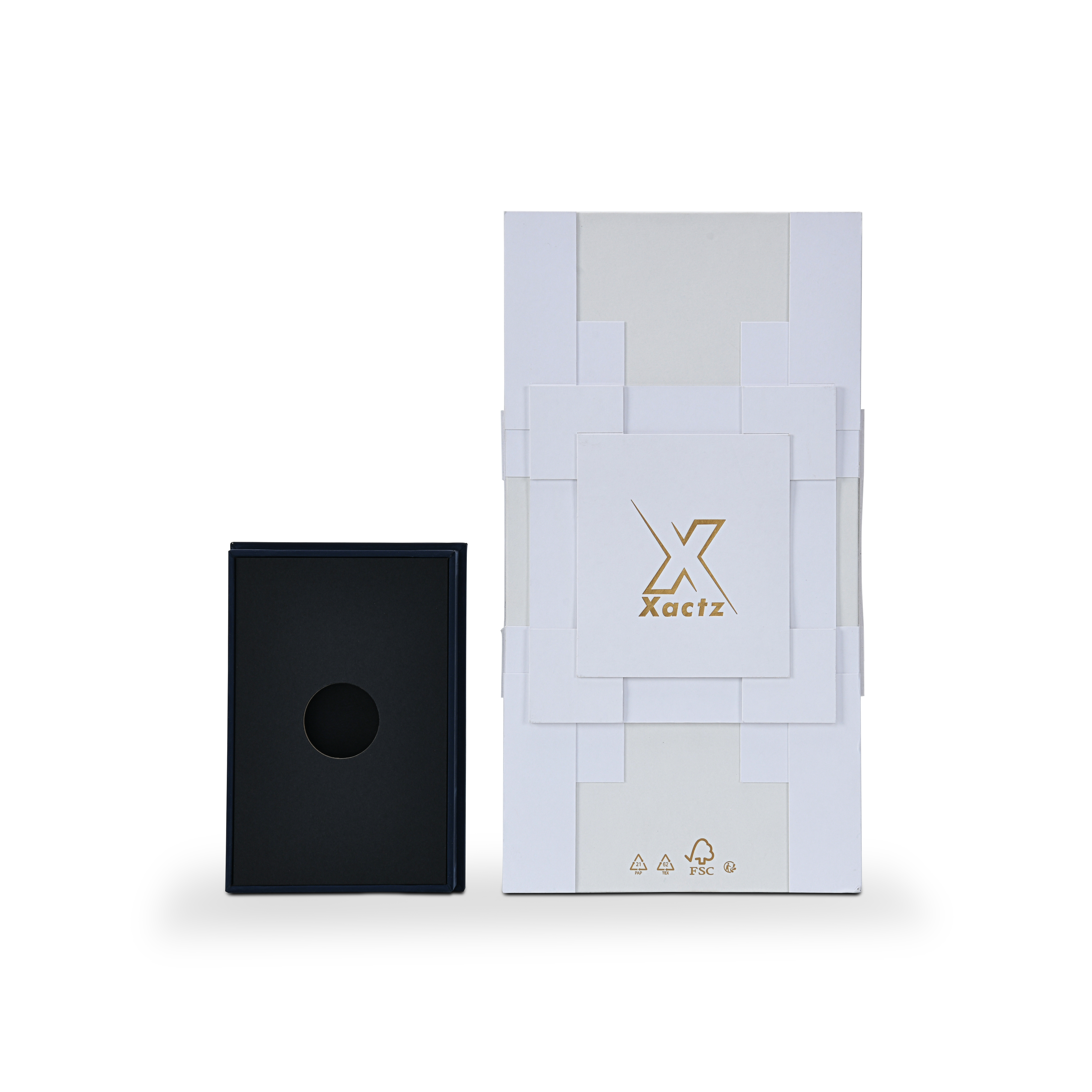 Overhead product presentation view showing the white geometric outer rigid box alongside a removable deep navy blue base insert with a circular bottle die-cut cutout.
