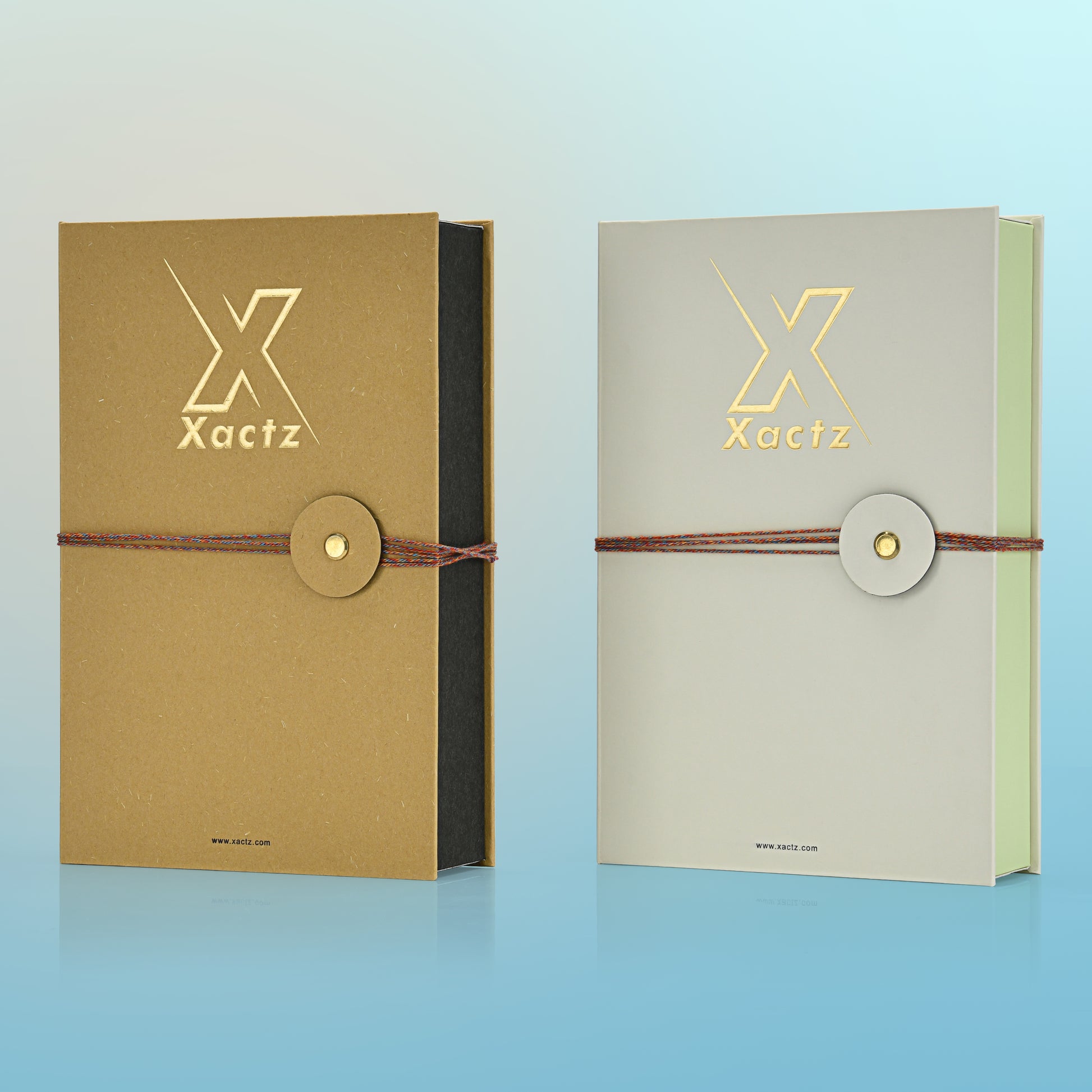 Angled front view of two custom book style fragrance boxes in ochre yellow and light grey showing the contrasting inner box colors of matte black and light green