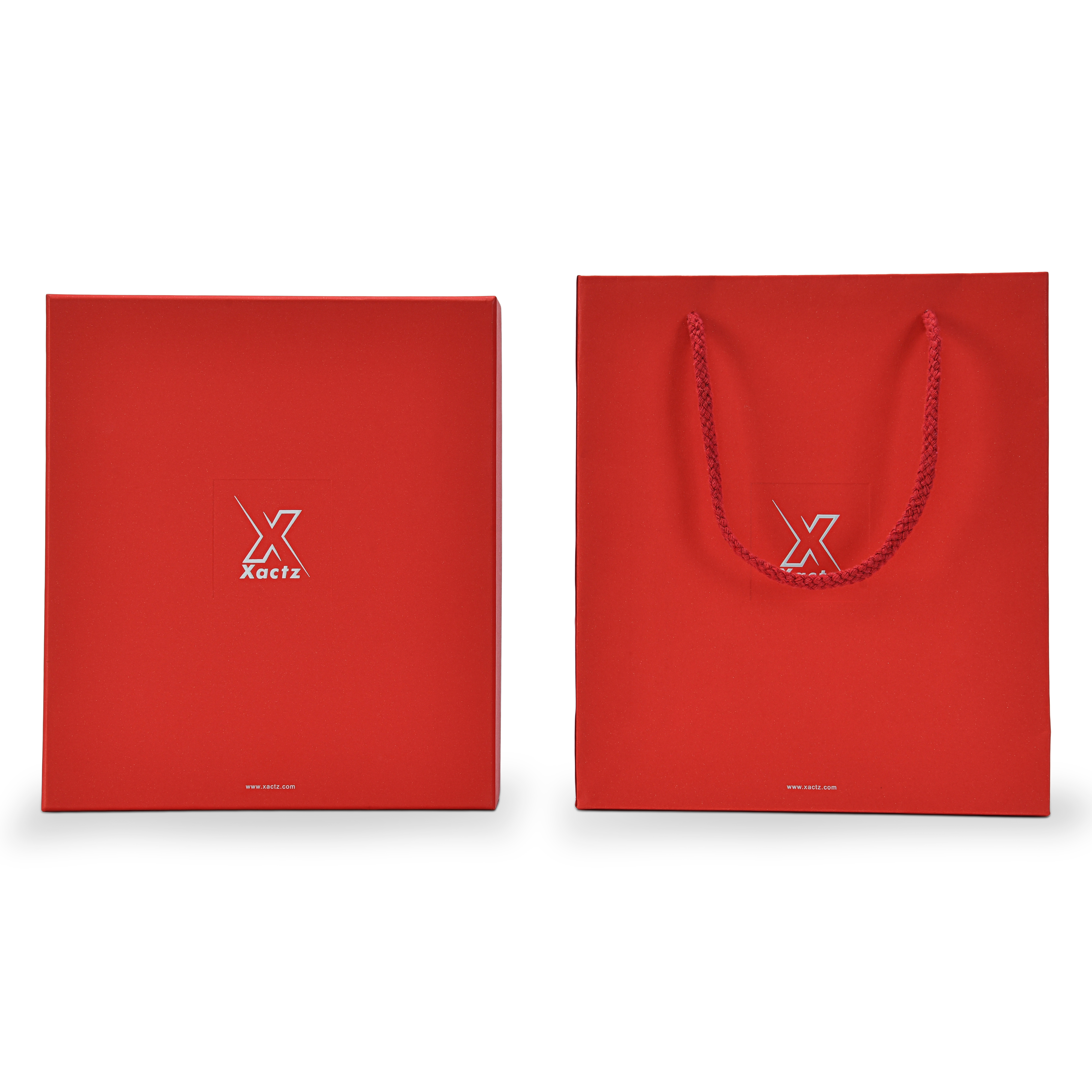 Front on view of a custom red lid and base gift box for cosmetics displayed beside its matching red specialty paper gift bag both featuring the embossed bright silver foil Xactz logo and silver foil website address with the gift bag showing a braided red rope handle and the complete premium red and silver packaging set