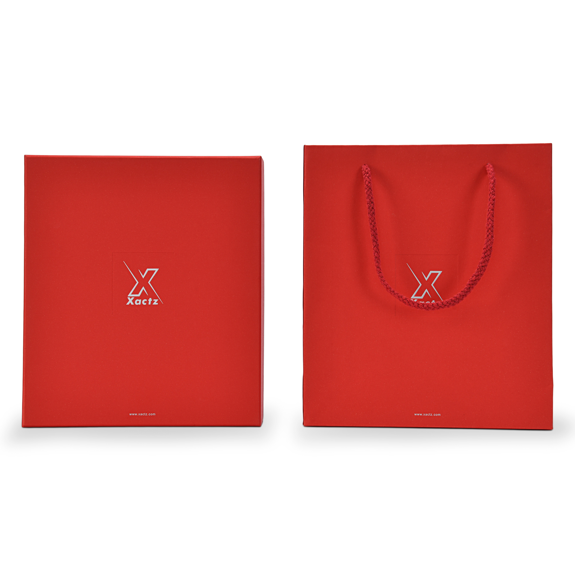 Front on view of a custom red lid and base gift box for cosmetics displayed beside its matching red specialty paper gift bag both featuring the embossed bright silver foil Xactz logo and silver foil website address with the gift bag showing a braided red rope handle and the complete premium red and silver packaging set