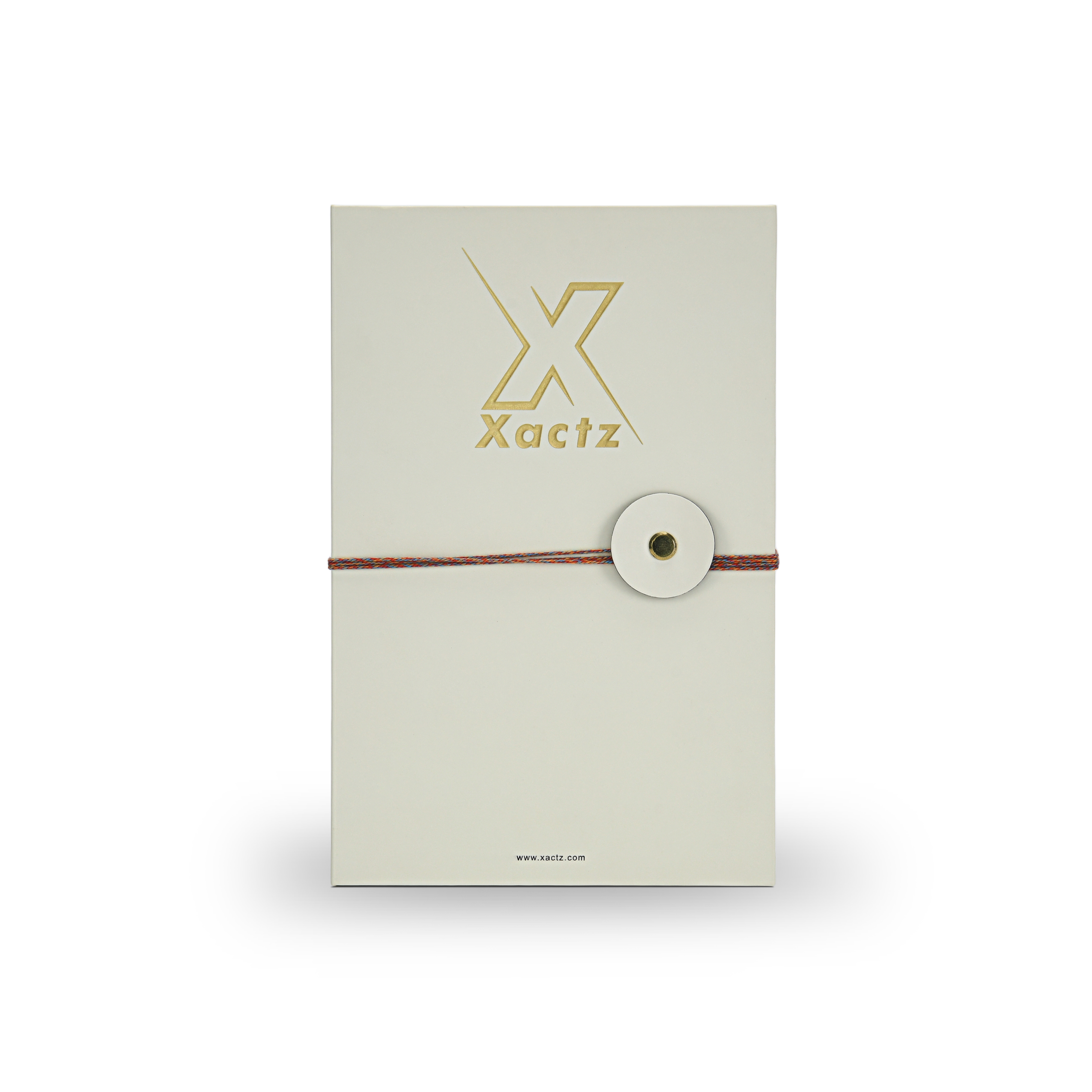 Premium cream book style rigid perfume gift box front view with embossed gold foil Xactz logo soft-touch matte lamination and multicolour rope closure with circular cream disc and gold metal rivet