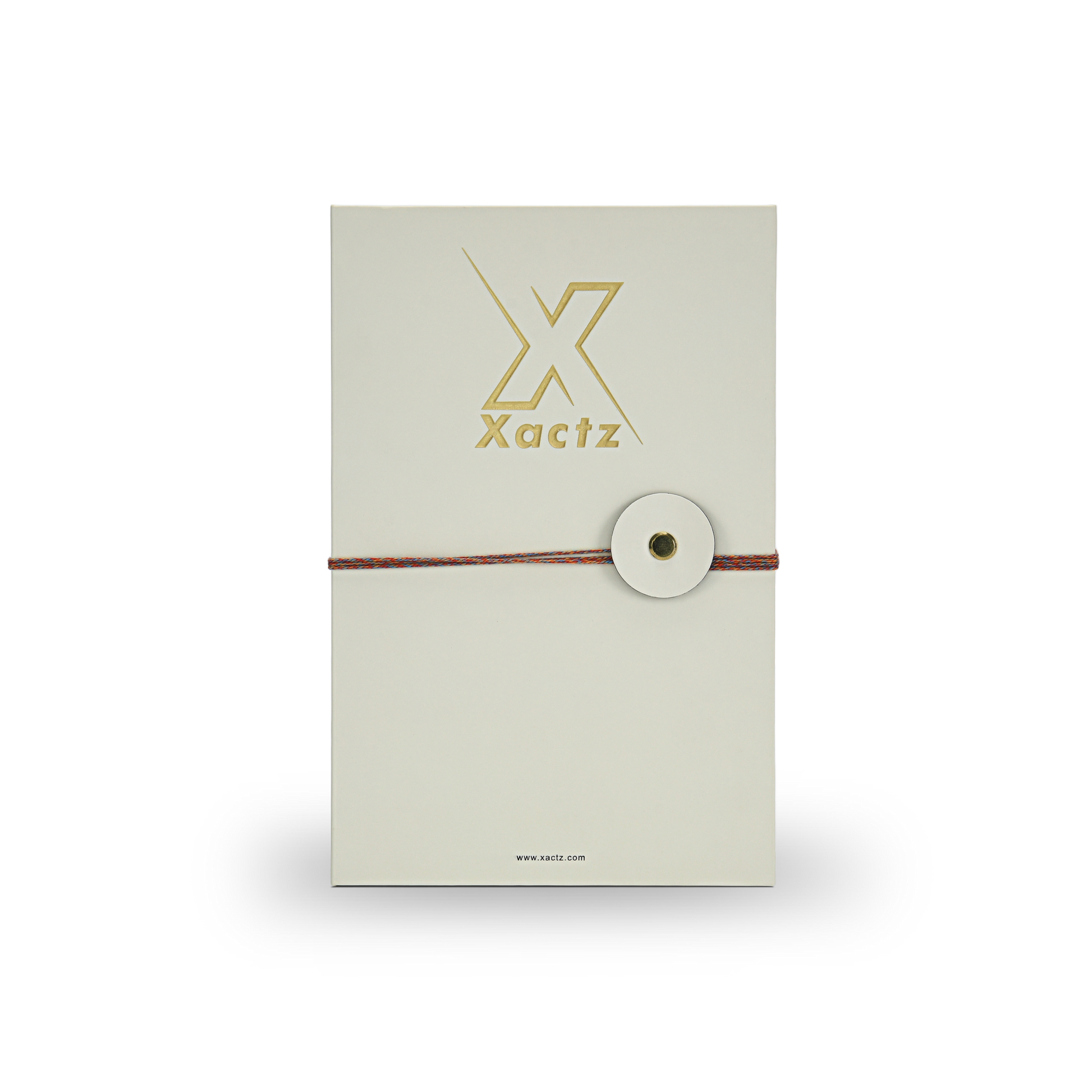 Premium cream book style rigid perfume gift box front view with embossed gold foil Xactz logo soft-touch matte lamination and multicolour rope closure with circular cream disc and gold metal rivet