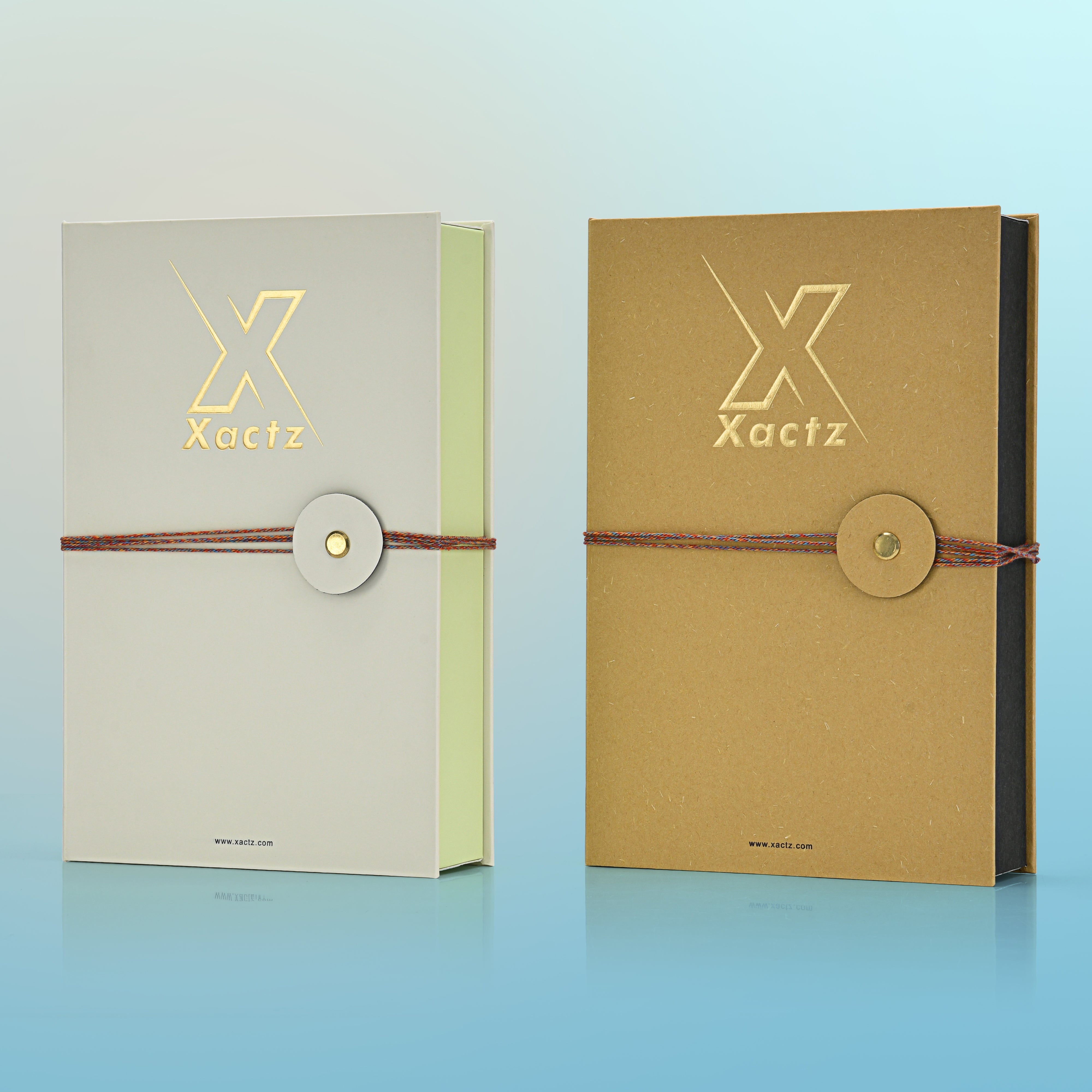 Premium cream and kraft rigid perfume packaging box three quarter angle comparison showing book style construction embossed gold foil logo pale green and black interior linings and multicolour rope closure on both colour variants