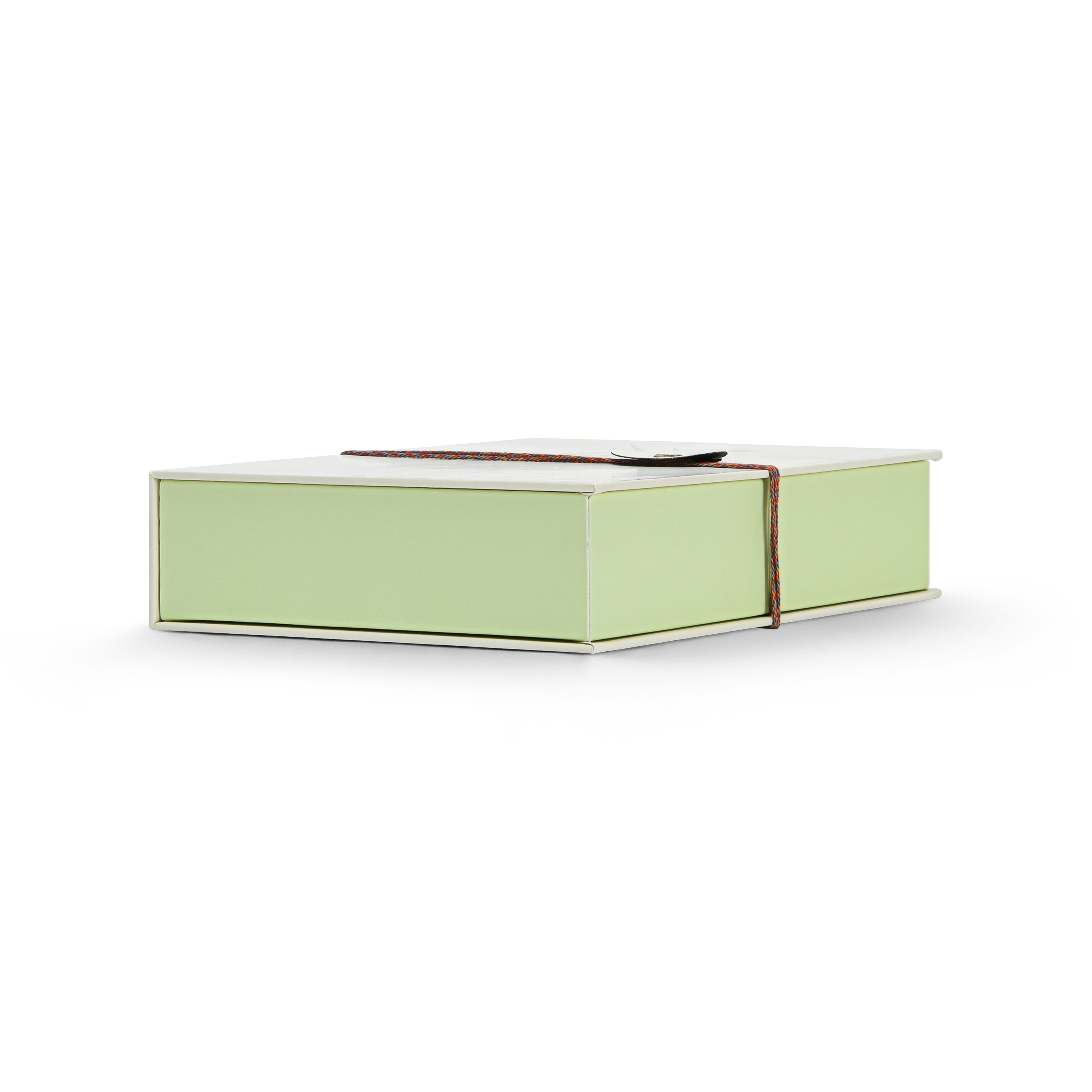 Luxury cream book style perfume gift box base view showing pale green rigid base construction multicolour rope closure and clean soft-touch matte laminated cream exterior finish