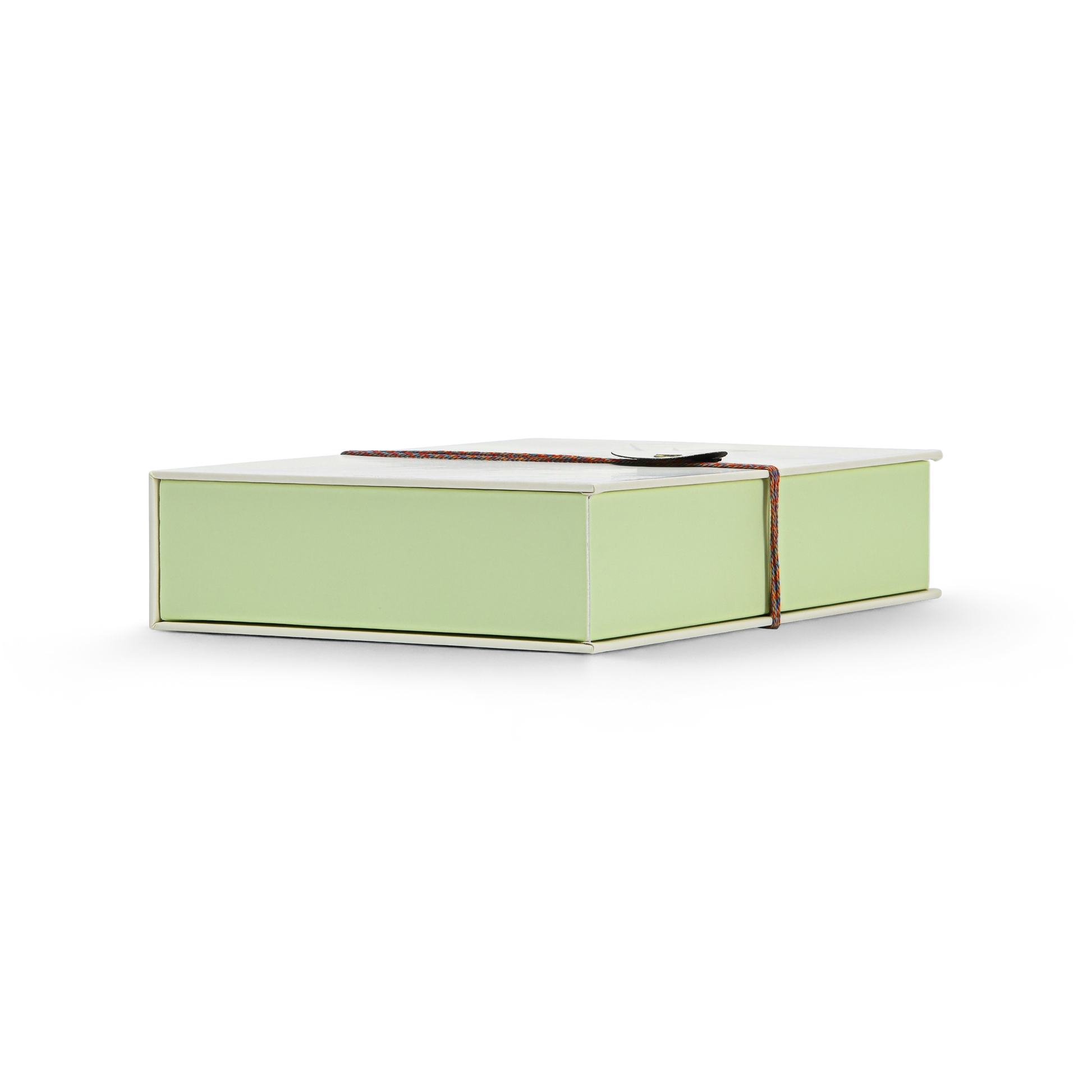 Luxury cream book style perfume gift box base view showing pale green rigid base construction multicolour rope closure and clean soft-touch matte laminated cream exterior finish