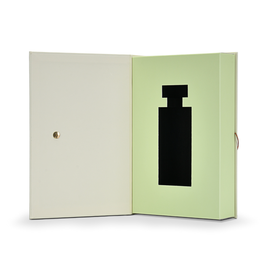 Premium cream book style perfume gift box fully open front view revealing pale green interior lining with custom black EVA die-cut perfume bottle shaped insert and gold metal rivet on cream interior lid
