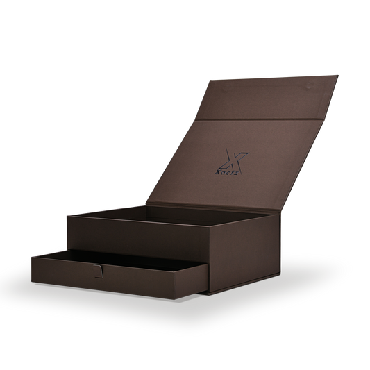 Luxury deep coffee brown magnetic gift box open three quarter view showing blind embossed Xactz logo on interior lid and lower pull ribbon drawer partially extended